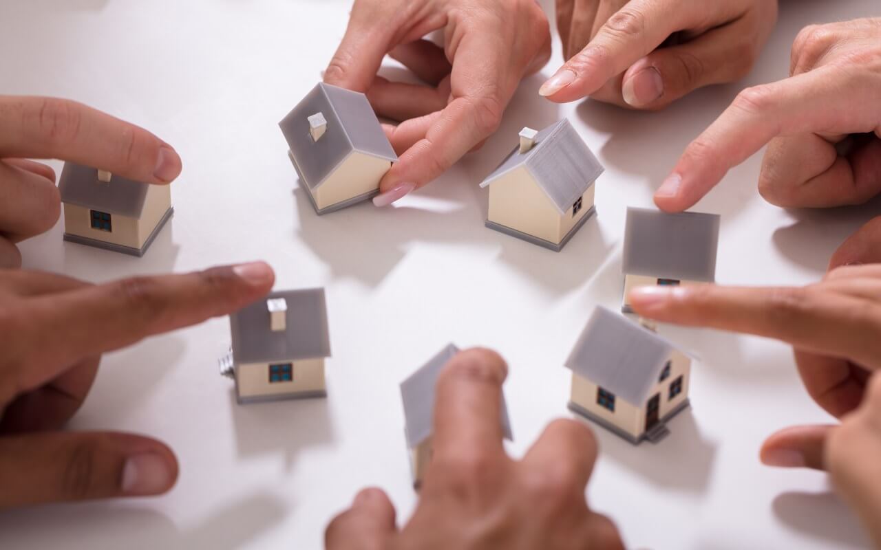 Social Housing - Multiple fingers pointing to houses