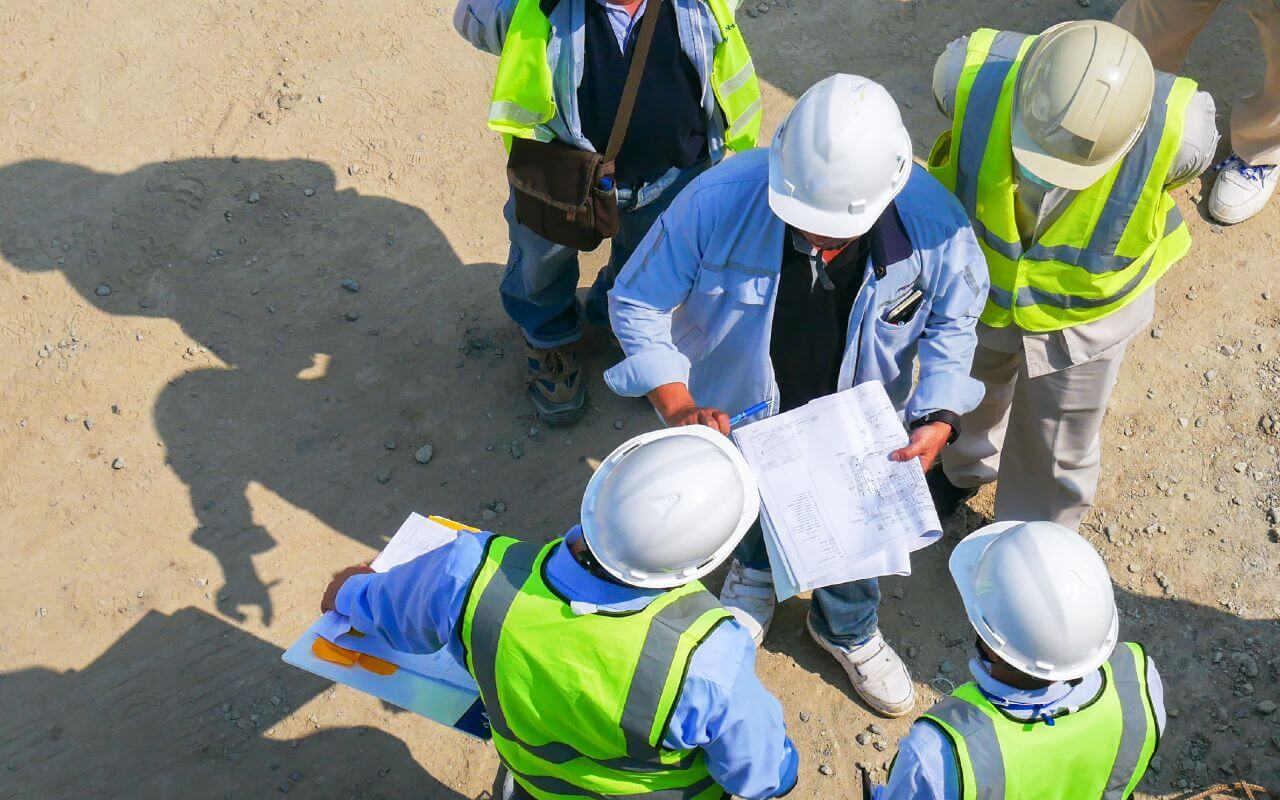 Construction workers talking at building site
