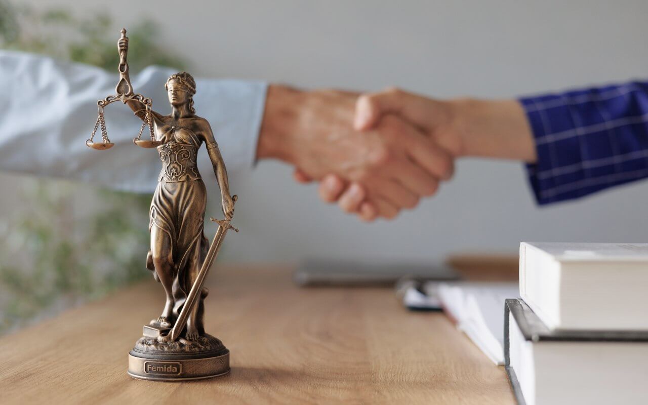 Dispute resolution lady justice in front of handshake