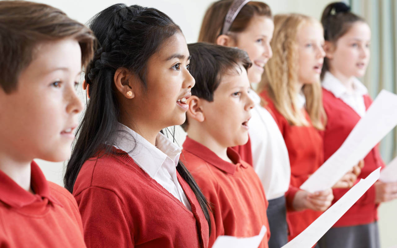 Students sing in choir at faith school
