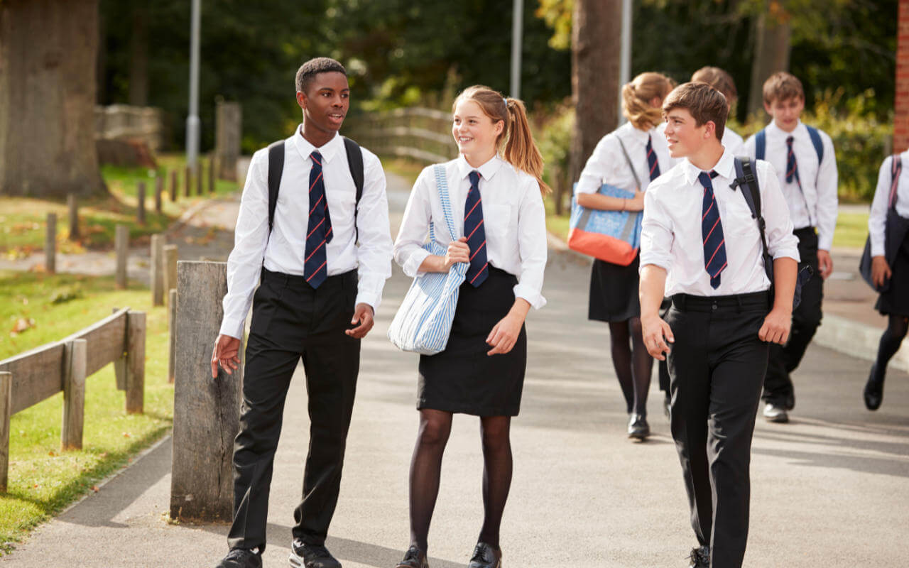 Teenagers walking to school in uniforms
