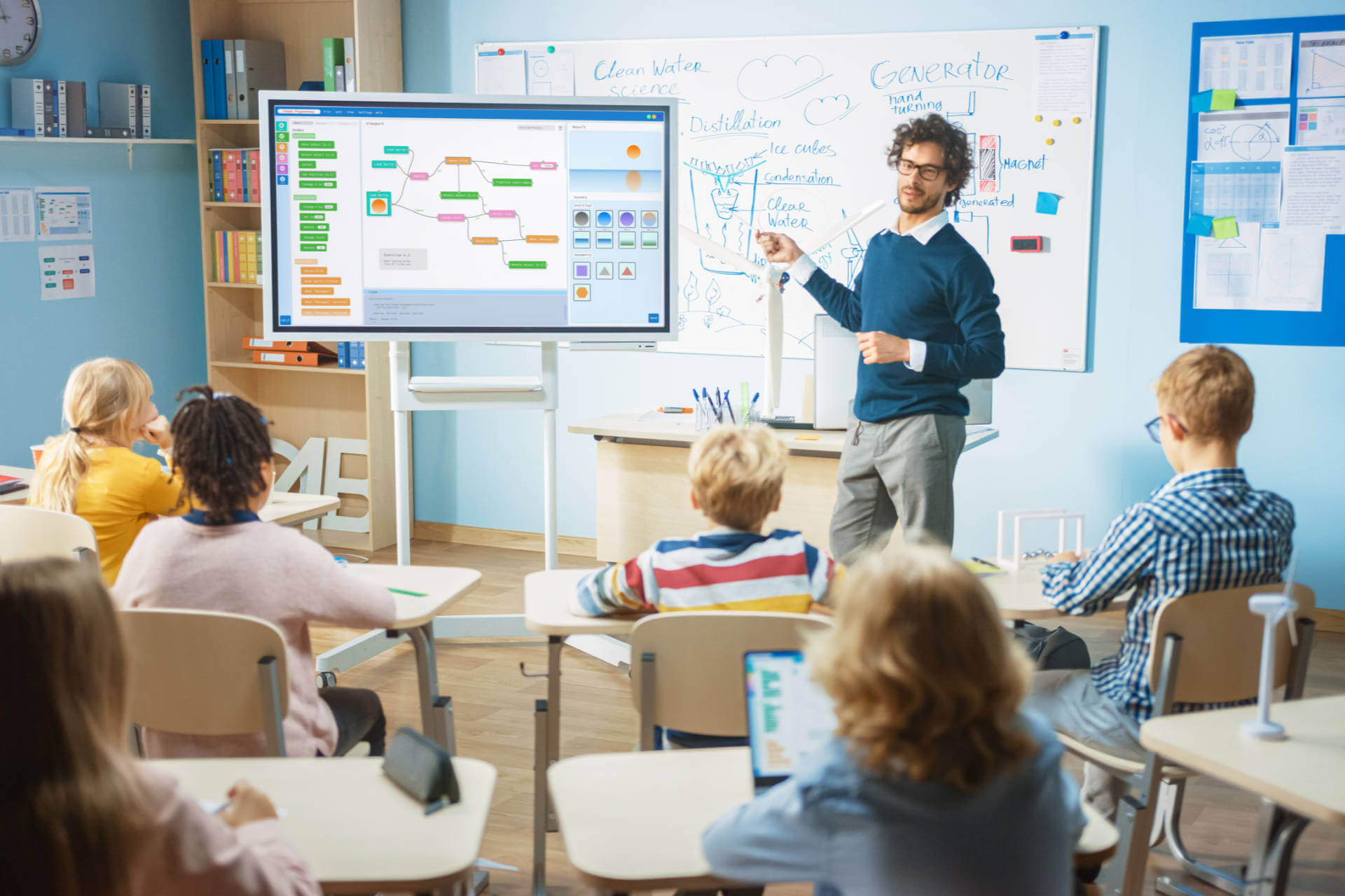Education teacher with smart board in front of science class