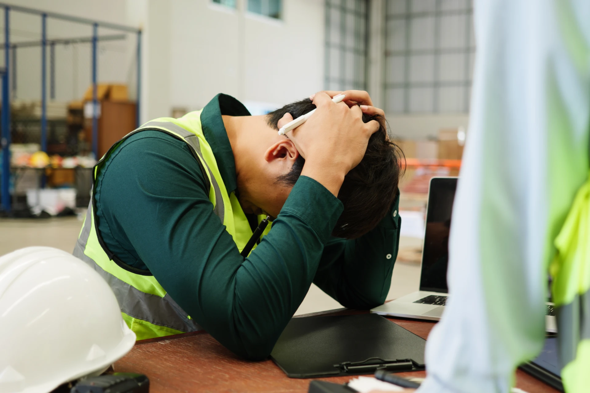 Unfair dismissal -warehouse worker with head in hands